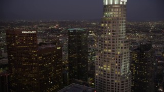 4.8K aerial stock footage fly over Two California Plaza in Downtown Los Angeles to reveal office buildings at night, California Aerial Stock Footage | AX69_083