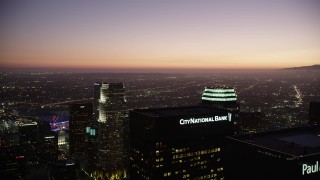 4.8K aerial stock footage fly over Downtown Los Angeles skyscrapers to approach 777 Tower at twilight, California Aerial Stock Footage | AX69_090