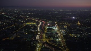 AX69_095 - 4.8K aerial stock footage of heavy traffic on Interstate 110 by University Park, Los Angeles, California at night