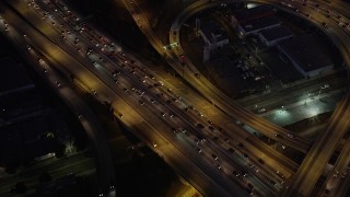 4.8K aerial stock footage of bird's eye view of the I-110 / 10 interchange in Downtown Los Angeles, California at night Aerial Stock Footage | AX69_097