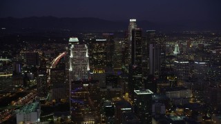 4.8K aerial stock footage tilt to reveal Staples Center, Nokia Theater, hotels, and skyscrapers in Downtown Los Angeles, California at night Aerial Stock Footage | AX69_098