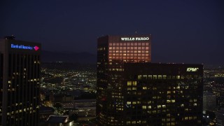 AX69_101 - 4.8K aerial stock footage fly between two skyscrapers in Downtown Los Angeles, California toward Boyle Heights at night