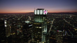 4.8K aerial stock footage of orbiting top of US Bank Tower in Downtown Los Angeles at nighttime, California Aerial Stock Footage | AX69_117