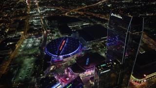 4.8K aerial stock footage approach and tilt to Staples Center and Nokia Theater in Downtown Los Angeles, California at night Aerial Stock Footage | AX69_126