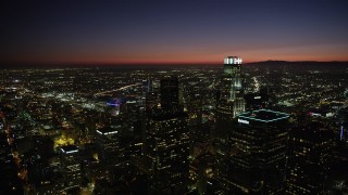 4.8K aerial stock footage reverse view of the towers of Downtown Los Angeles at nighttime, California Aerial Stock Footage | AX69_132