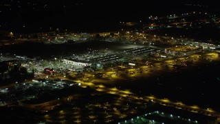 4.8K aerial stock footage of a strip mall by Burbank Airport terminals at night in Burbank, California Aerial Stock Footage | AX69_147