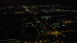 4.8K aerial stock footage of Pacoima warehouse buildings on San Fernando Road at nighttime, California Aerial Stock Footage | AX69_152