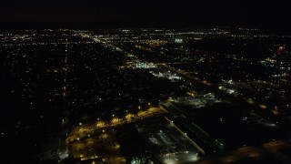 4.8K aerial stock footage tilt to reveal suburban Pacoima neighborhoods and Whiteman Airport at night, California Aerial Stock Footage | AX69_153