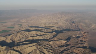 AX70_030 - 4K aerial stock footage Mountain ridges at sunrise, Cuyama, California