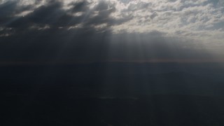 4K aerial stock footage Godrays shining down from the clouds over San Luis Obispo County, California Aerial Stock Footage | AX70_076