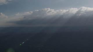 4K aerial stock footage Rays of sunshine shining on mountains from clouds over San Luis Obispo County, California Aerial Stock Footage | AX70_081