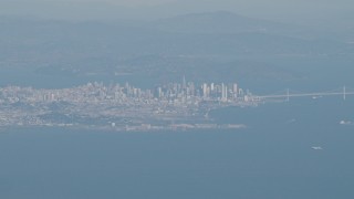 4K aerial stock footage Downtown San Francisco, the Bay Bridge as a jet airliner passes, California Aerial Stock Footage | AX70_094