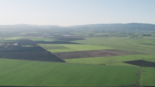 AX70_105 - 4K aerial stock footage Flying over large crop fields in Hollister, California