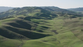 AX70_139 - 4K aerial stock footage Flying over green hills in Paicines, California