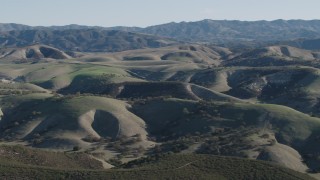 4K aerial stock footage Flyby green hills with trees in San Benito County, California Aerial Stock Footage | AX70_169