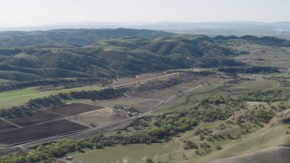 4K aerial stock footage An approach to small farms and green hills in San Benito County, California Aerial Stock Footage | AX70_182