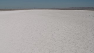 4K aerial stock footage Tilt and fly low over Soda Lake in California Aerial Stock Footage | AX70_214