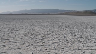 4K aerial stock footage Fly low over Soda Lake in California, to approach desert mountains Aerial Stock Footage | AX70_217