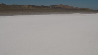 AX70_222 - 4K aerial stock footage Tilt from a bird's eye view of Soda Lake in California to reveal desert mountains