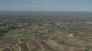 4K aerial stock footage Passing rural homes, vineyards, and a pond in Paso Robles, California Aerial Stock Footage | AX70_224