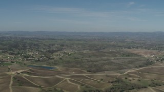 4K aerial stock footage Flyby rural homes, vineyards, and a pond in Paso Robles, California Aerial Stock Footage | AX70_225