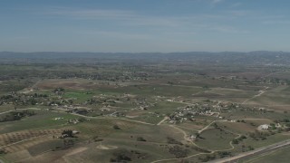 4K aerial stock footage Flyby rural homes and vineyards, reveal State Route 46 in Paso Robles, California Aerial Stock Footage | AX70_227