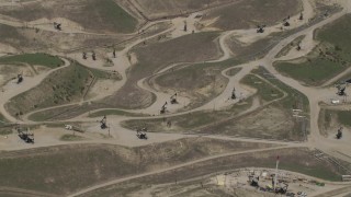 AX70_234 - 4K aerial stock footage bird's eye view of oil rigs in a field in San Ardo, California