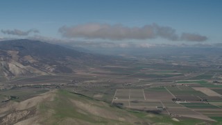 4K aerial stock footage Approach a cloud over farm fields in Greenfield, California Aerial Stock Footage | AX70_241