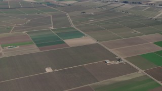 AX70_250 - 4K aerial stock footage Vineyards and fields around the Monterey Pacific winery in Soledad, California