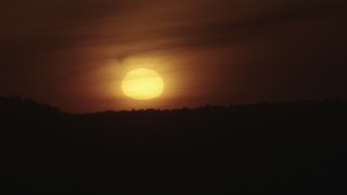 4K aerial stock footage of the sun setting behind mountains in Southern California Aerial Stock Footage | AX70_283