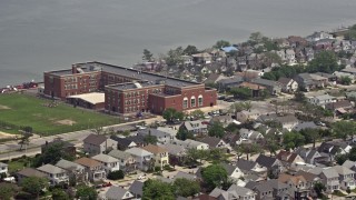 AX71_026 - 5.1K aerial stock footage of Lindell Elementary School beside Reynold's Channel in Long Beach, Long Island, New York