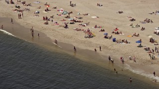 AX71_049 - 5.1K aerial stock footage of sunbathers on a Sandy Hook beach, Highlands, Jersey Shore