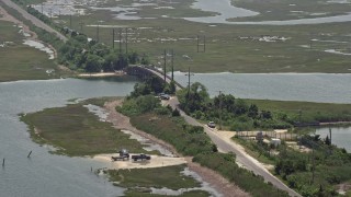 5.1K aerial stock footage of people fishing off of a small footbridge in Ocean County, New Jersey Aerial Stock Footage | AX71_153