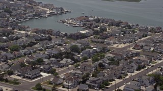 AX71_254 - 5.1K aerial stock footage of waterfront homes by Snug Harbor in Stone Harbor, New Jersey