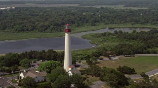 5.1K aerial stock footage orbiting Cape May Lighthouse by Lighthouse Pond, New Jersey Aerial Stock Footage | AX72_008