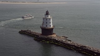 5.1K aerial stock footage orbiting Harbor of Refuge Light, Delaware and reveal a passing ferry Aerial Stock Footage | AX72_025