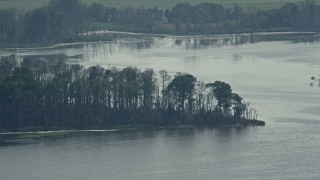 AX72_043E - 5.1K aerial stock footage of a tree-lined inlet by Delaware Bay