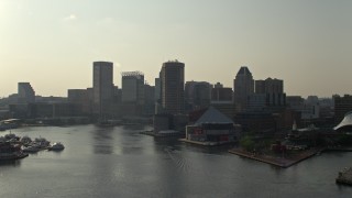 AX73_128E - 5.1K aerial stock footage flying low toward Inner Harbor and National Aquarium in Downtown Baltimore, Maryland