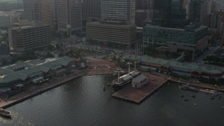 5.1K aerial stock footage of USS Constellation and the Pratt Street Pavilion in Downtown Baltimore, Maryland Aerial Stock Footage | AX73_130