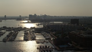 5.1K aerial stock footage of boats docked at the Baltimore Marine Center by riverfront office buildings, Maryland Aerial Stock Footage | AX73_145