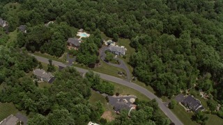 4.8K aerial stock footage flying over spacious mansions mansions and tilt to one of the homes in Clifton, Virginia Aerial Stock Footage | AX74_009