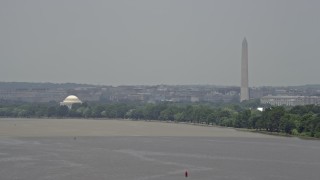 AX74_034 - 4.8K aerial stock footage of the Jefferson Memorial and the Washington Monument seen from the Potomac River in Washington DC