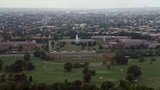 AX74_049 - 4.8K aerial stock footage of schools and a football field in Washington D.C.