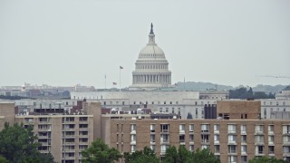 AX74_064E - 4.8K aerial stock footage of the United States Capitol Dome seen from apartment buildings in Washington DC