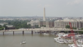 AX74_067E - 4.8K aerial stock footage approaching bridge, government office buildings, and Washington Monument in Washington DC