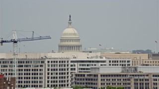 4.8K aerial stock footage of United States Capitol Dome seen above office buildings in Washington DC Aerial Stock Footage | AX74_089E