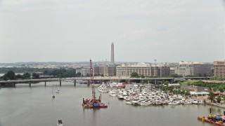 4.8K aerial stock footage of Francis Case Memorial Bridge and office buildings near Washington Monument in Washington DC Aerial Stock Footage | AX74_092