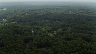 4.8K aerial stock footage flying over forest with a few upscale homes in Fairfax Station, Virginia Aerial Stock Footage | AX74_141E