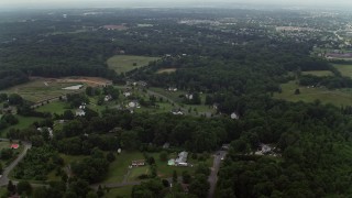 4.8K aerial stock footage flying over forest to approach rural homes in Manassas, Virginia Aerial Stock Footage | AX74_146E