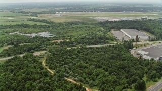 AX74_152E - 4.8K aerial stock footage flying over Prince William Parkway intersection to approach Manassas Regional Airport, Virginia